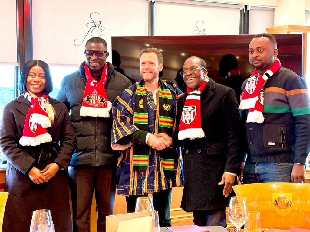 Group photo with hosts in kente and scarves